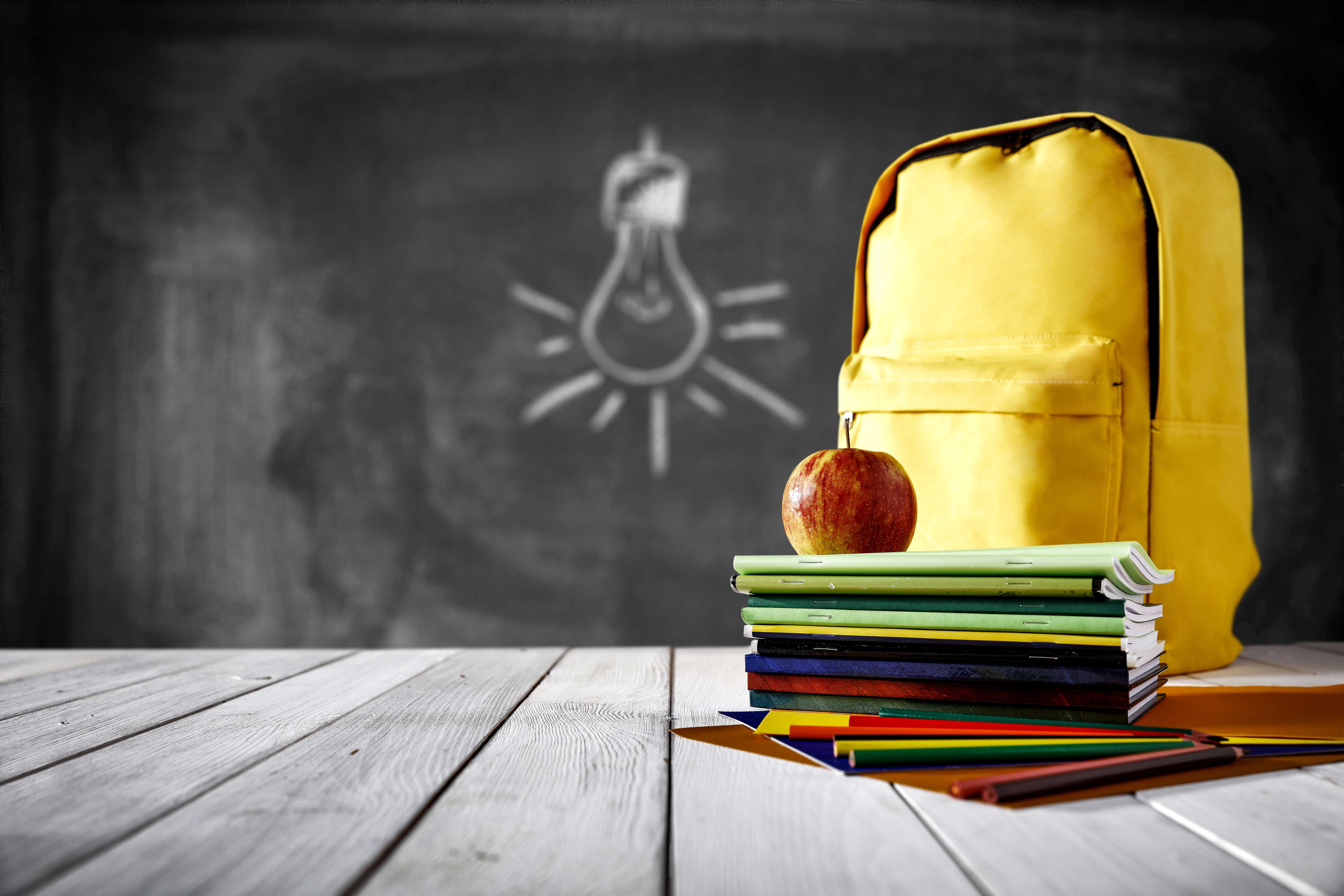 School supplies and back pack on table