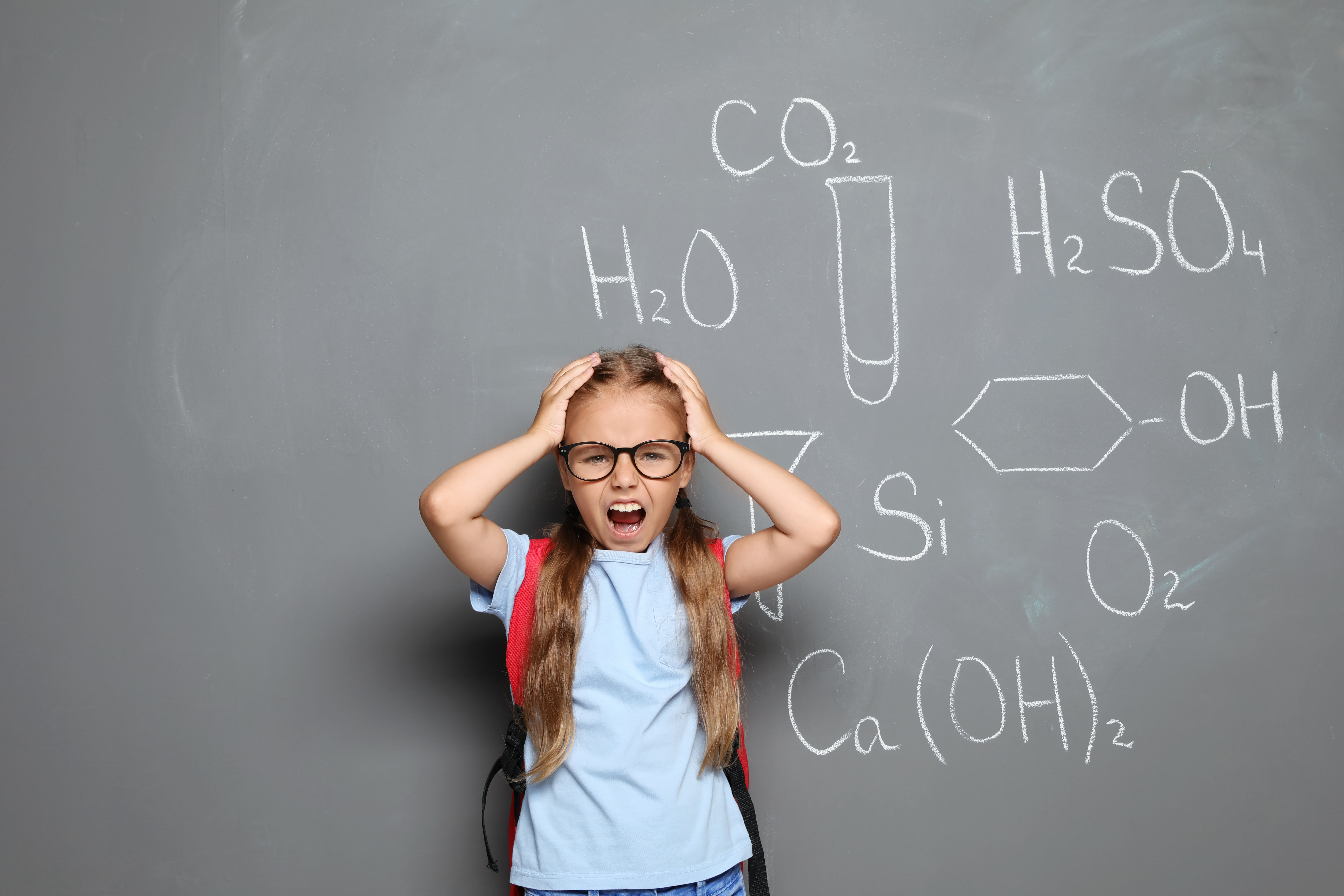 A frustrated girl in front of the blackboard